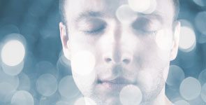 Man with eyes closed doing creative visualization, mind power training