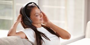 Woman with eyes closed listening to music with headphones, how to increase mind power