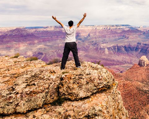 How To Build Self-confidence, Man Standing At Grand Canyon Arms Outstretched