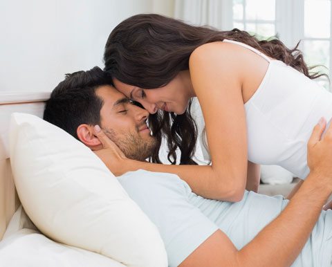 How To Have Better Sex, Couple In Bed Holding Each Other With Eyes Closed.