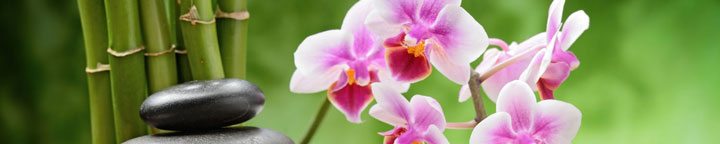  total wellness, stack of stones, bamboo, pink orchids, towel