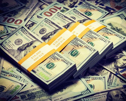 Creating Wealth Stacks Of Money On Pile Of Hundred Dollar Bills