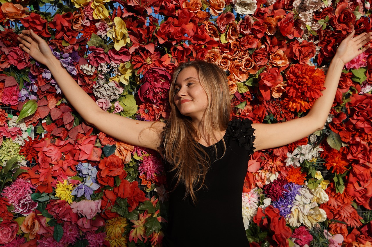 benefits of meditation happy woman laying on a bed of flowers