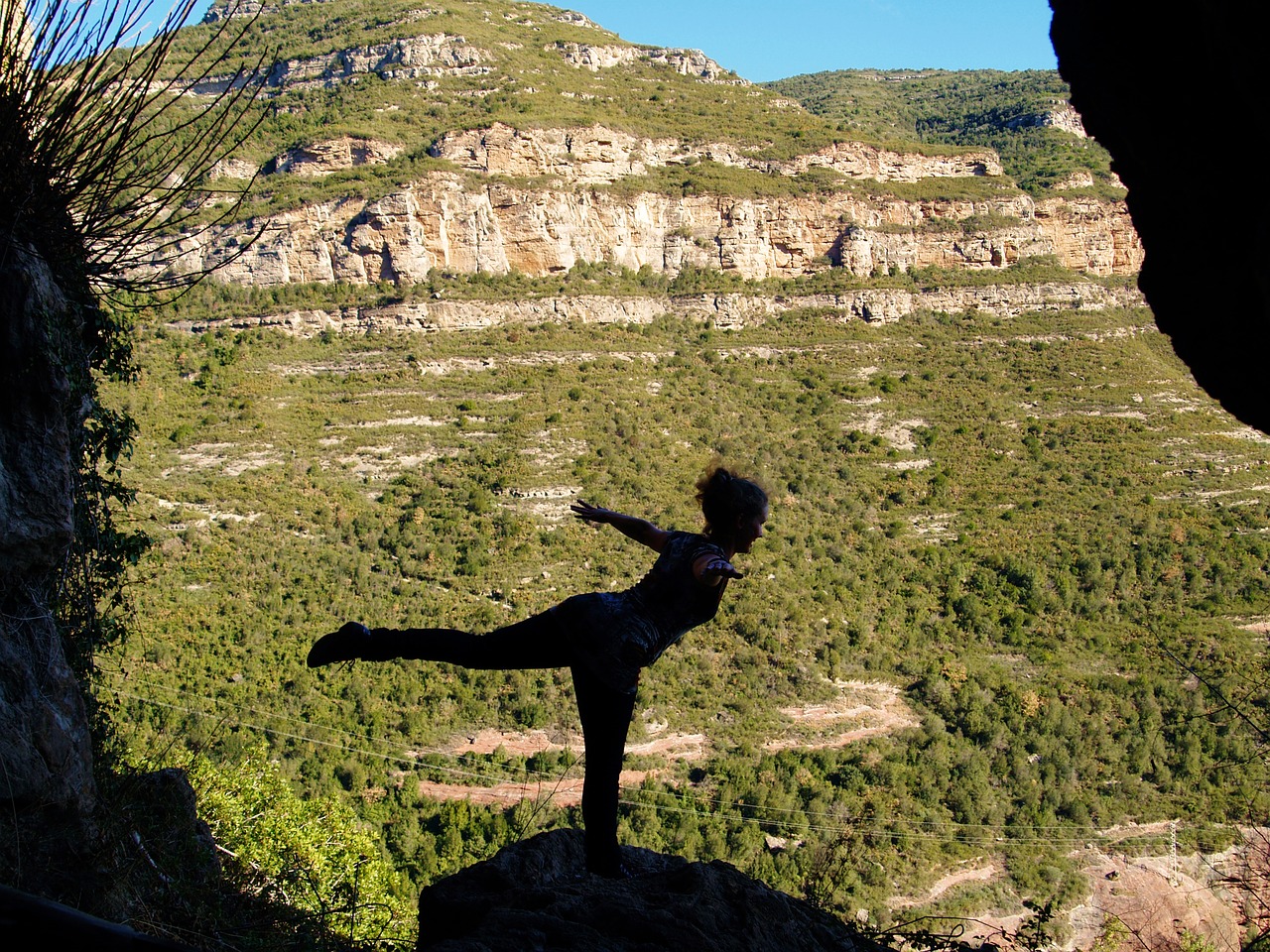 Positive affirmations woman balancing on one foot leaning outstretched with mountains