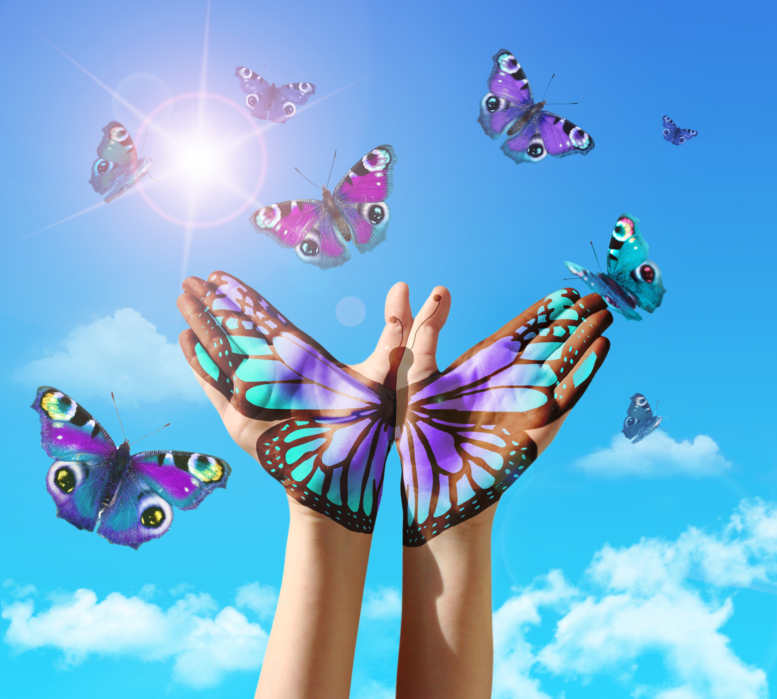 Self Hypnosis Audio - The palm of two hands painted to create one butterfly against a blue sky with lots of butterfly about