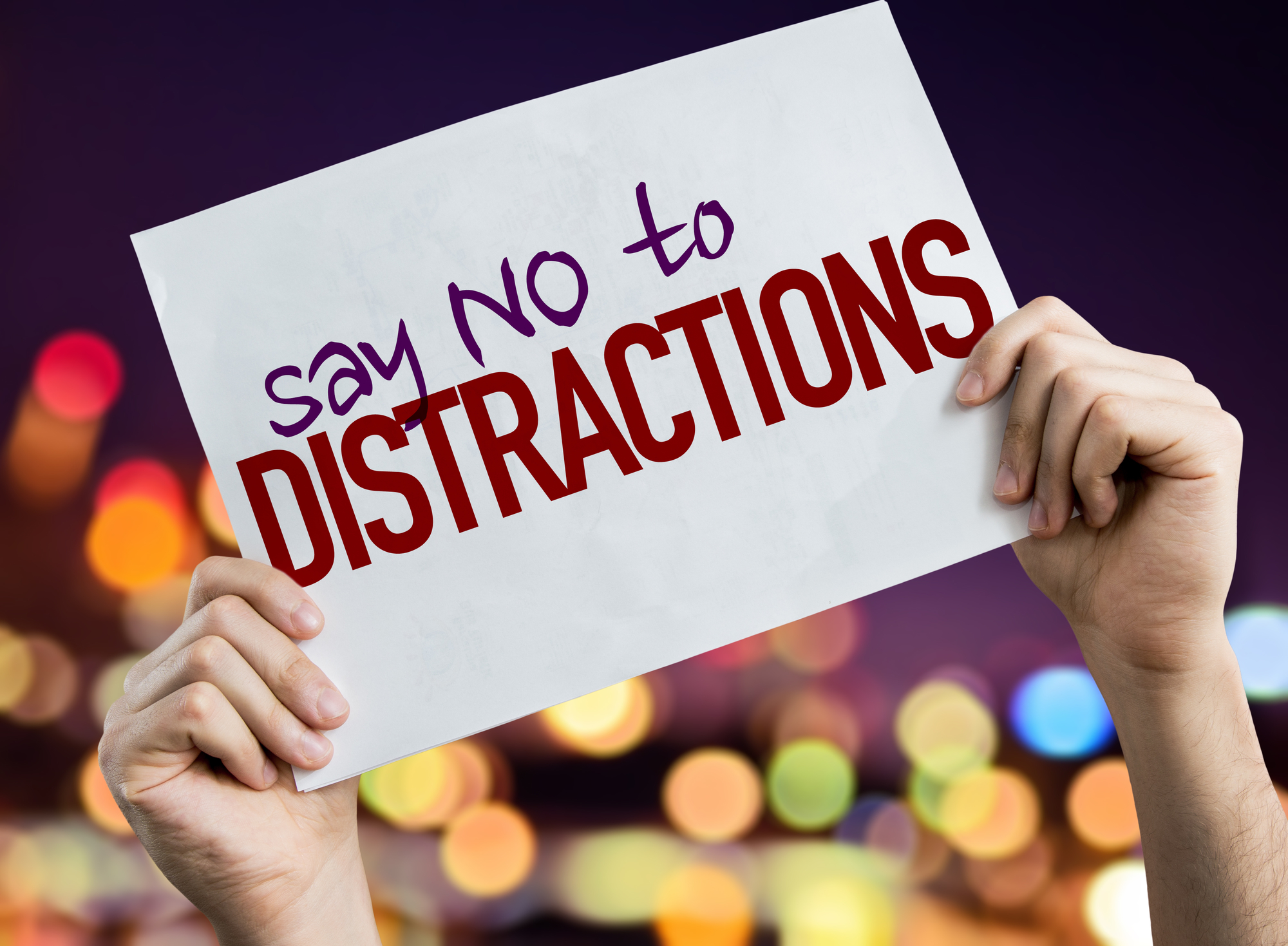 Mind power techniques-sign being held up stating "say no to Distractions"