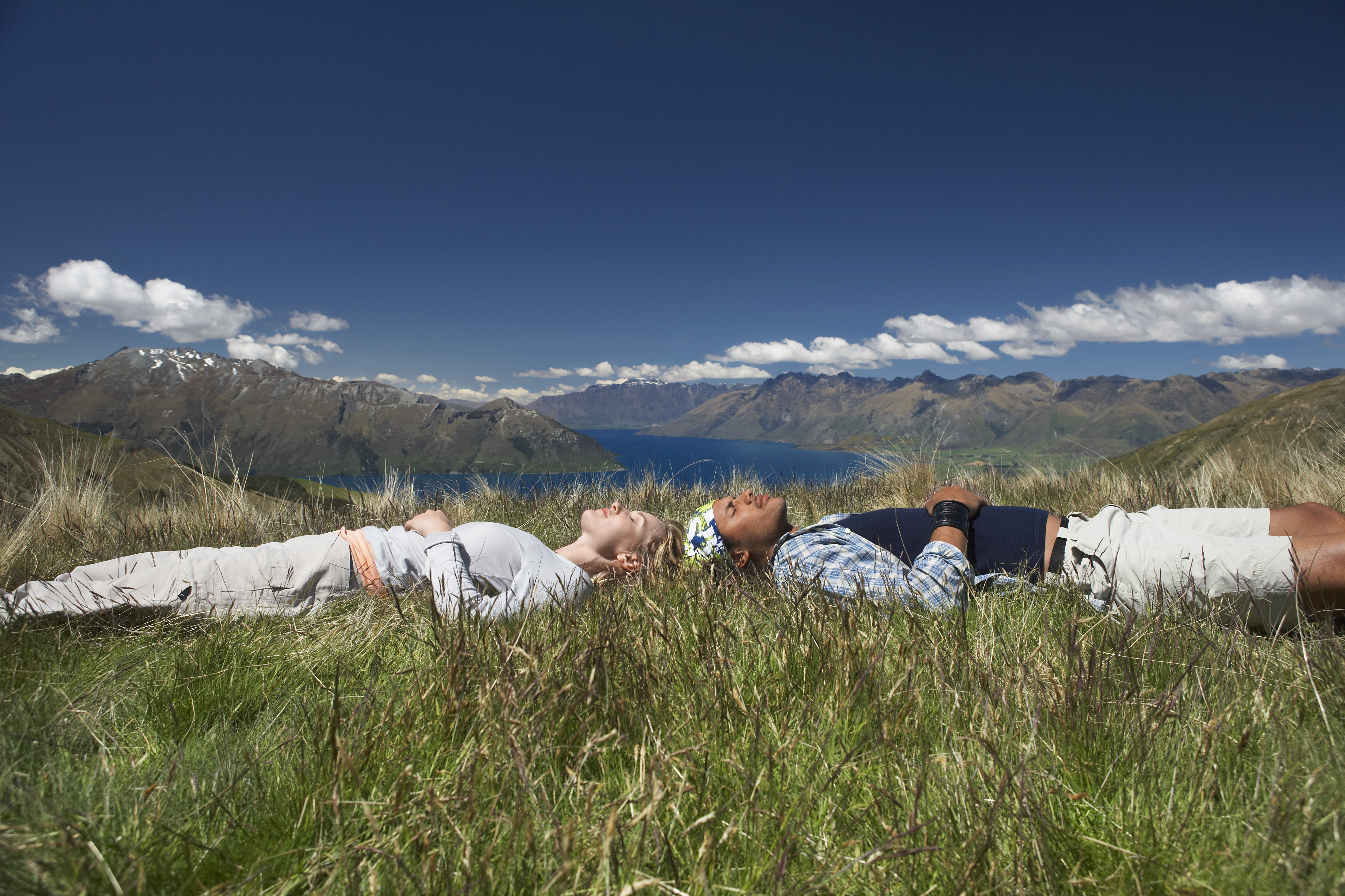 Nature sounds for sleep -a couple laying head to head in a field over looking a high rive mountain scape