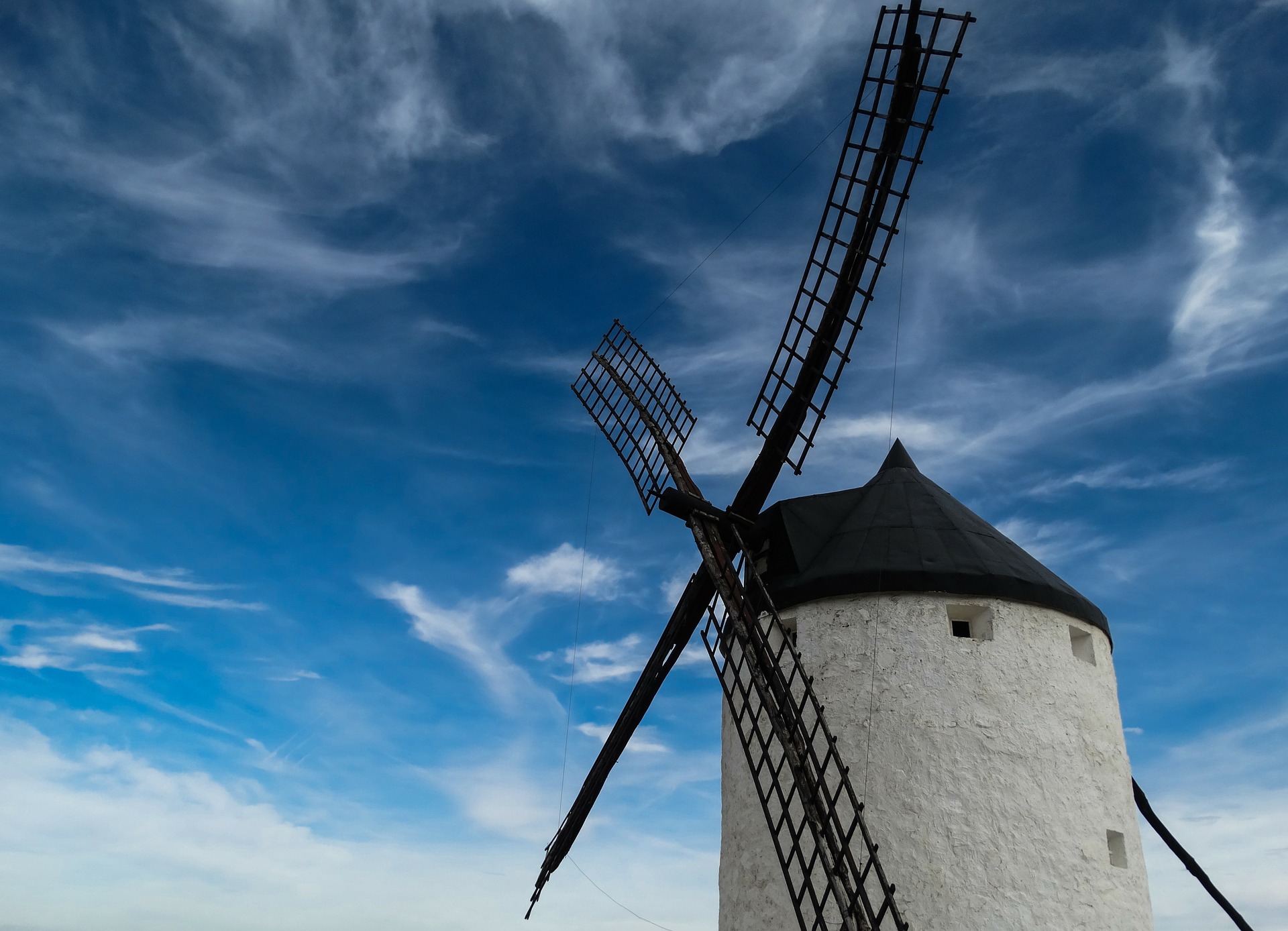 Nature sounds for sleep -a black and white windmill set against a blue sky with wispy clouds