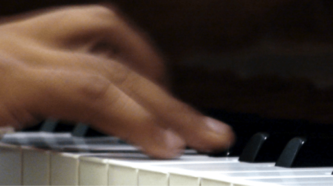 Music Therapy - A Blurry Close Up Of A Hand Playing The Piano