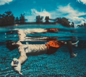 financial prosperity boy staying afloat surrounded by trees and clouds