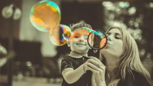 manifesting your desires - mother and son blowing bubbles