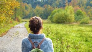 self confidence tips - woman hiking on a quiet road